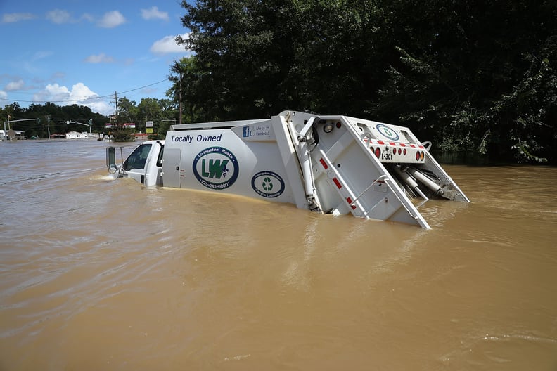 A swamped garbage truck illustrates just how high the waters are.