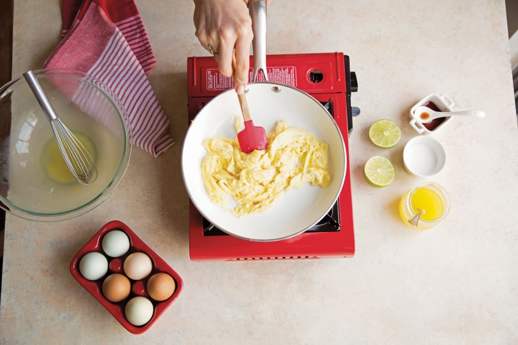 Add the eggs to the hot pan and let them sit for 10 seconds. Using a rubber spatula, push and flip the eggs around the pan, stirring constantly, for 4 to 5 minutes, until the eggs are just cooked through.