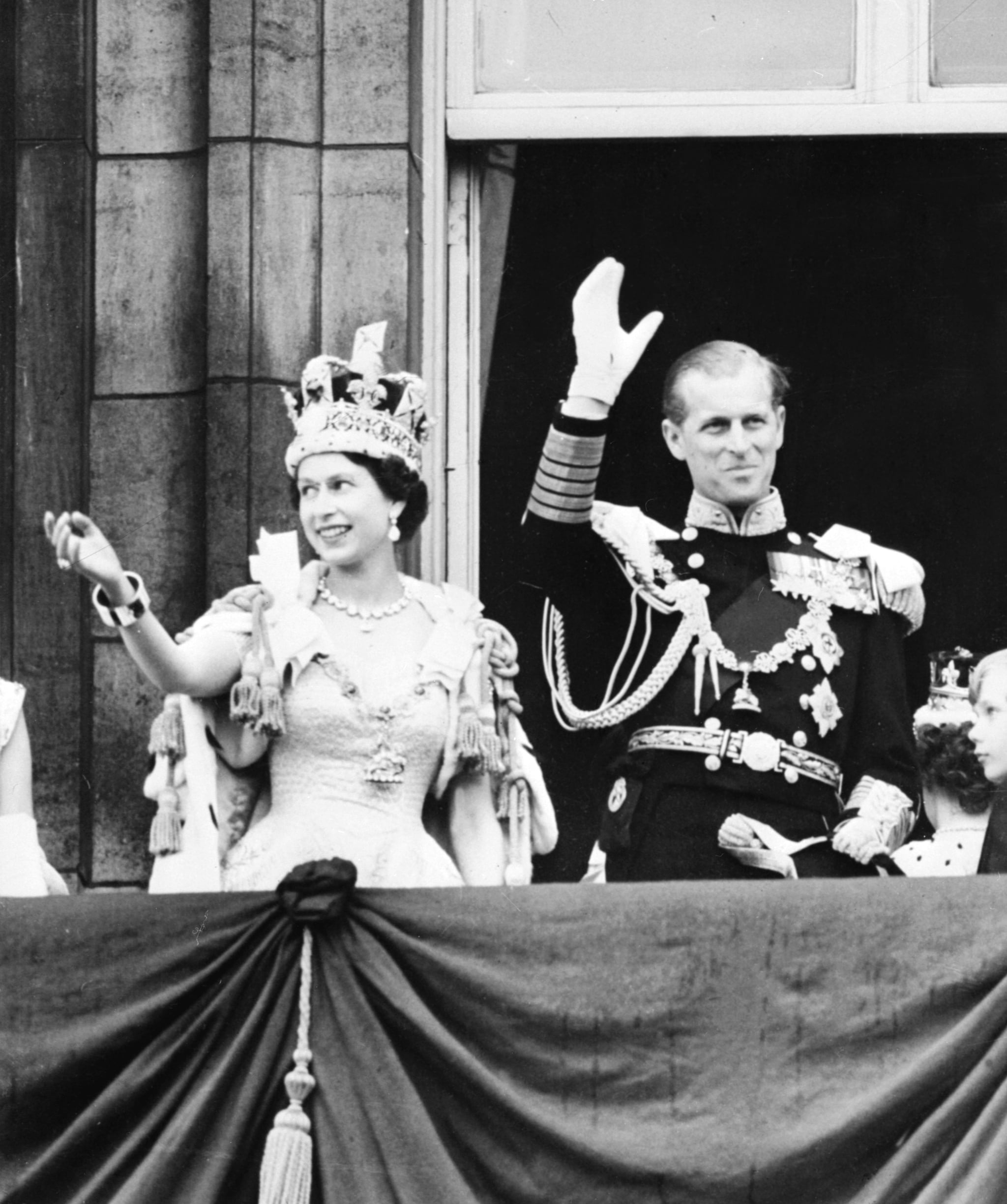LONDON, UNITED KINGDOM - JUNE 2:  Queen Elizabeth II accompanied by Prince Philip waves to the crowd, 02 June 1953 after being crowned solemnly at Westminter Abbey in London. Elizabeth married the Duke of Edinburgh on the 20th of November 1947 and was proclaimed Queen in 1952 at age 25. Her coronation was the first worldwide televised event.  (Photo credit should read STF/AFP/Getty Images)