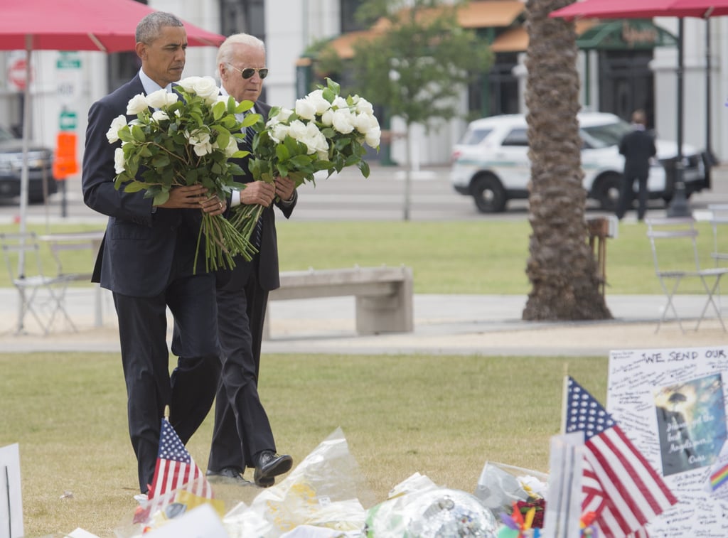 President Obama and Vice President Biden carry white roses to place at a memorial for the victims of the Orlando shooting.