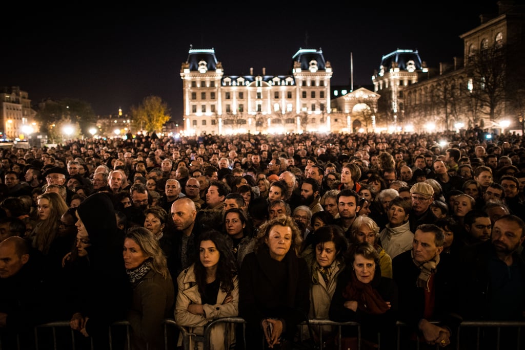 People gathered outside of Paris's Notre Dame Cathedral for a ceremony to honor the victims.