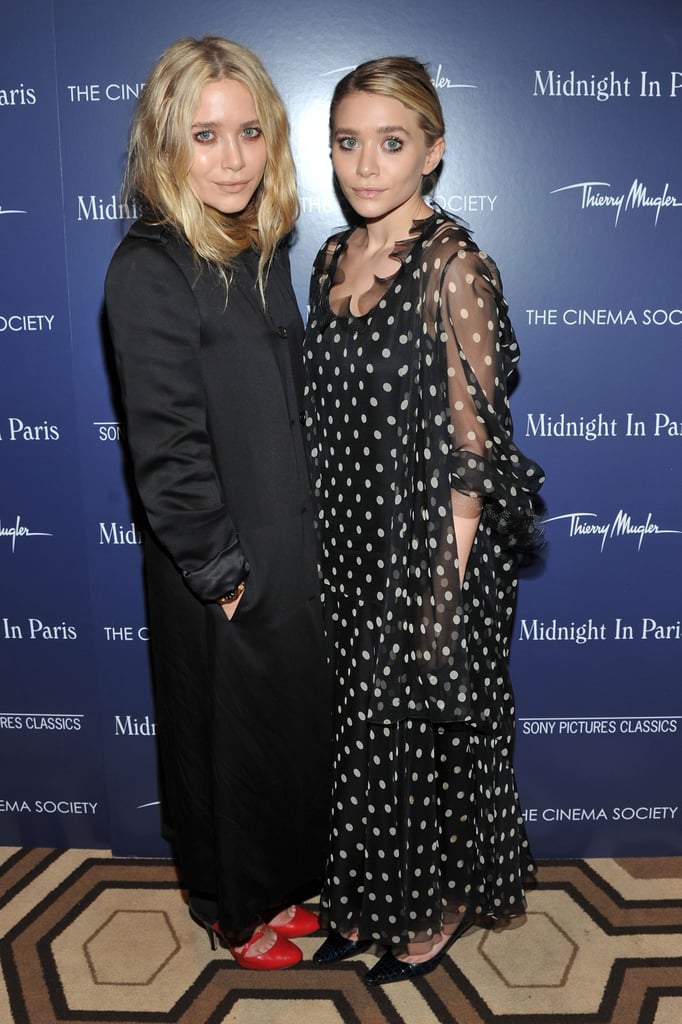 Twinning combo: The Olsens hit the NYC screening of Midnight in Paris oozing Parisian-chic sophistication.

Mary-Kate warmed up in a long black silk coat and fiery red rounded pumps.
Ashley looked whimsical in a sheer polka-dot dress and black crocodile pumps.