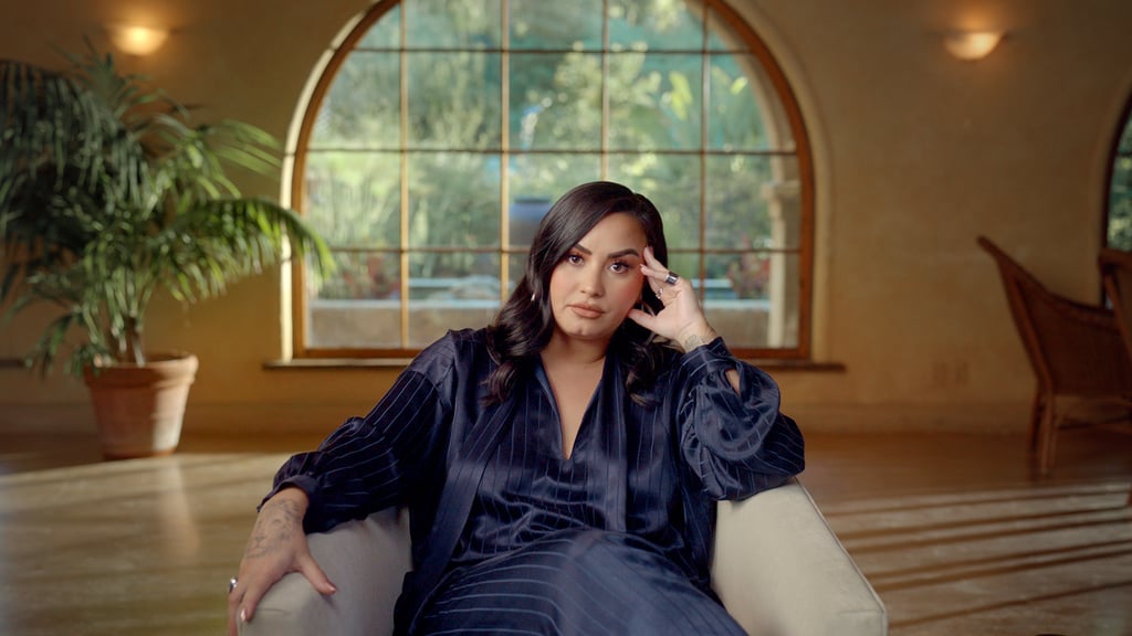 In a rare moment of repose, Lovato wore a navy silk ensemble in Dancing with the Devil in 2020.