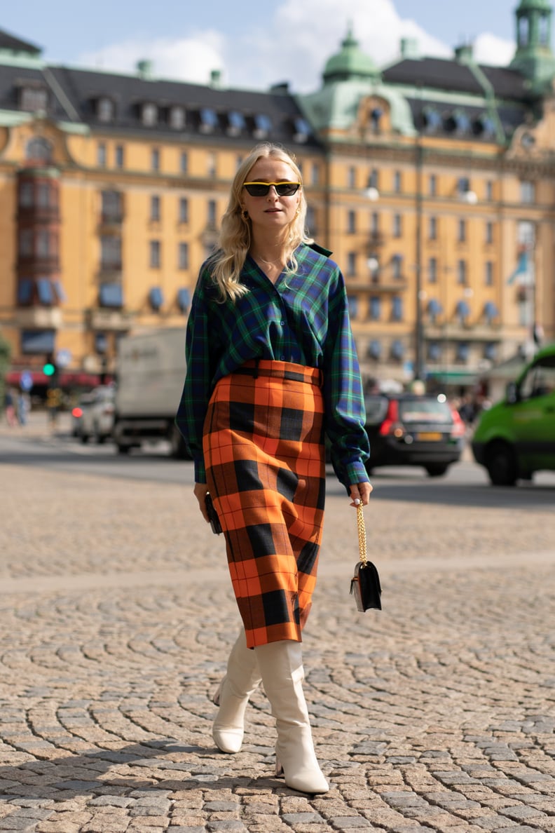 A plaid pencil skirt and plaid button-down might feel busy, but stark white boots temper the busy prints