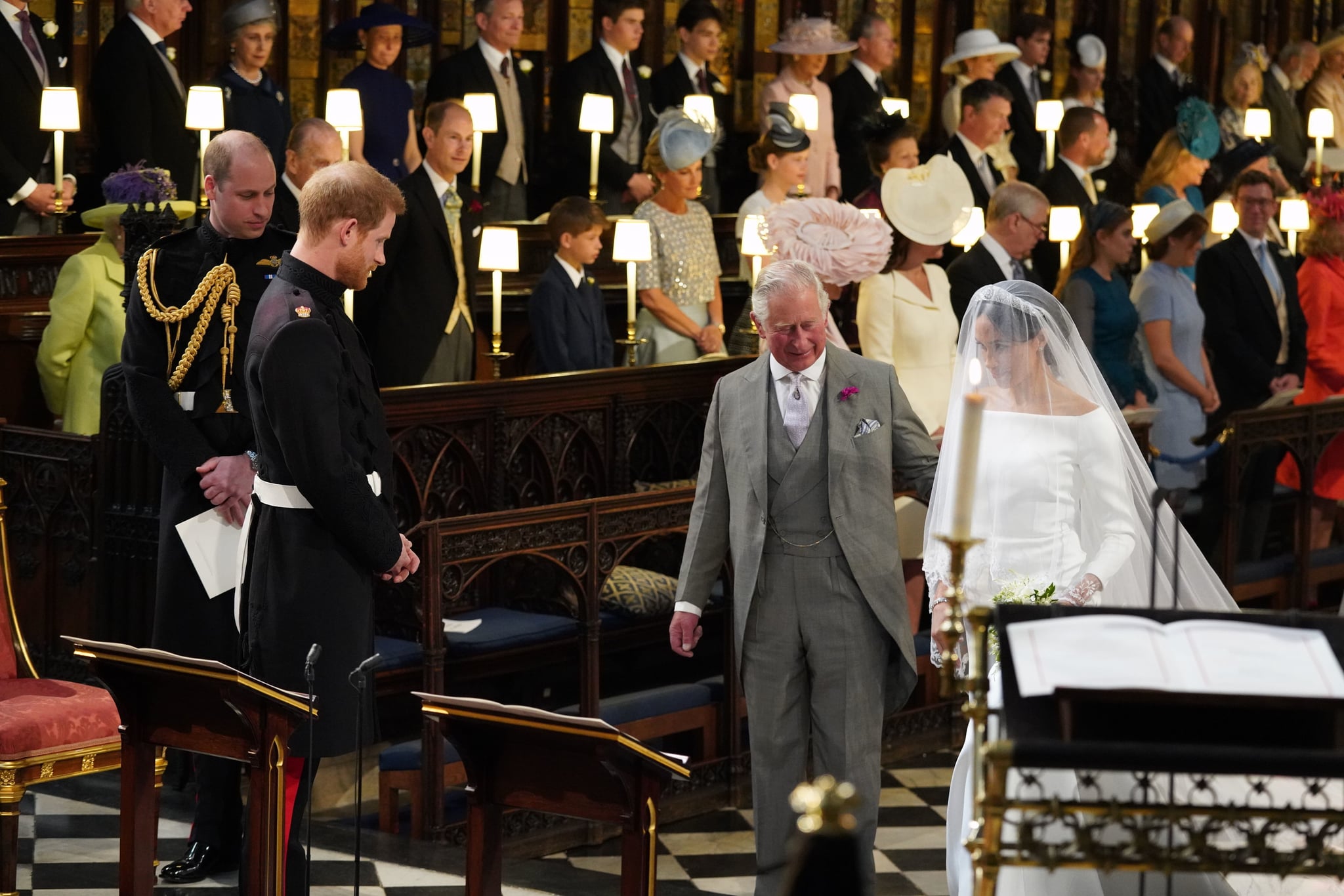 WINDSOR, UNITED KINGDOM - MAY 19: Prince Harry looks at his wife, Meghan Markle, while she arrives accompanied by Prince Charles, Prince of Wales, at their wedding at St George's Chapel in Windsor Castle on May 19, 2018 in Windsor, England. (Photo by Jonathan Brady - Pool WPA / Getty Images)