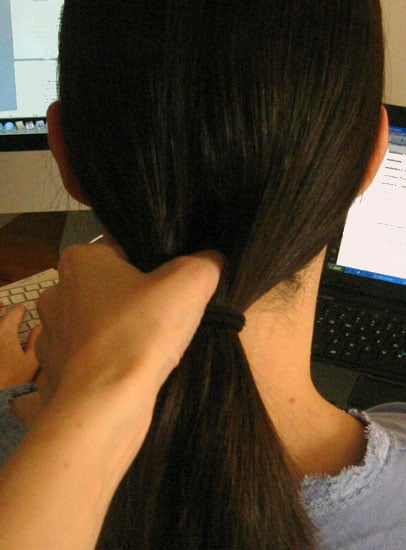 Use your fingers to separate hair above ponytail holder, creating a hole. Use your fingers to separate hair above ponytail holder, creating a hole.