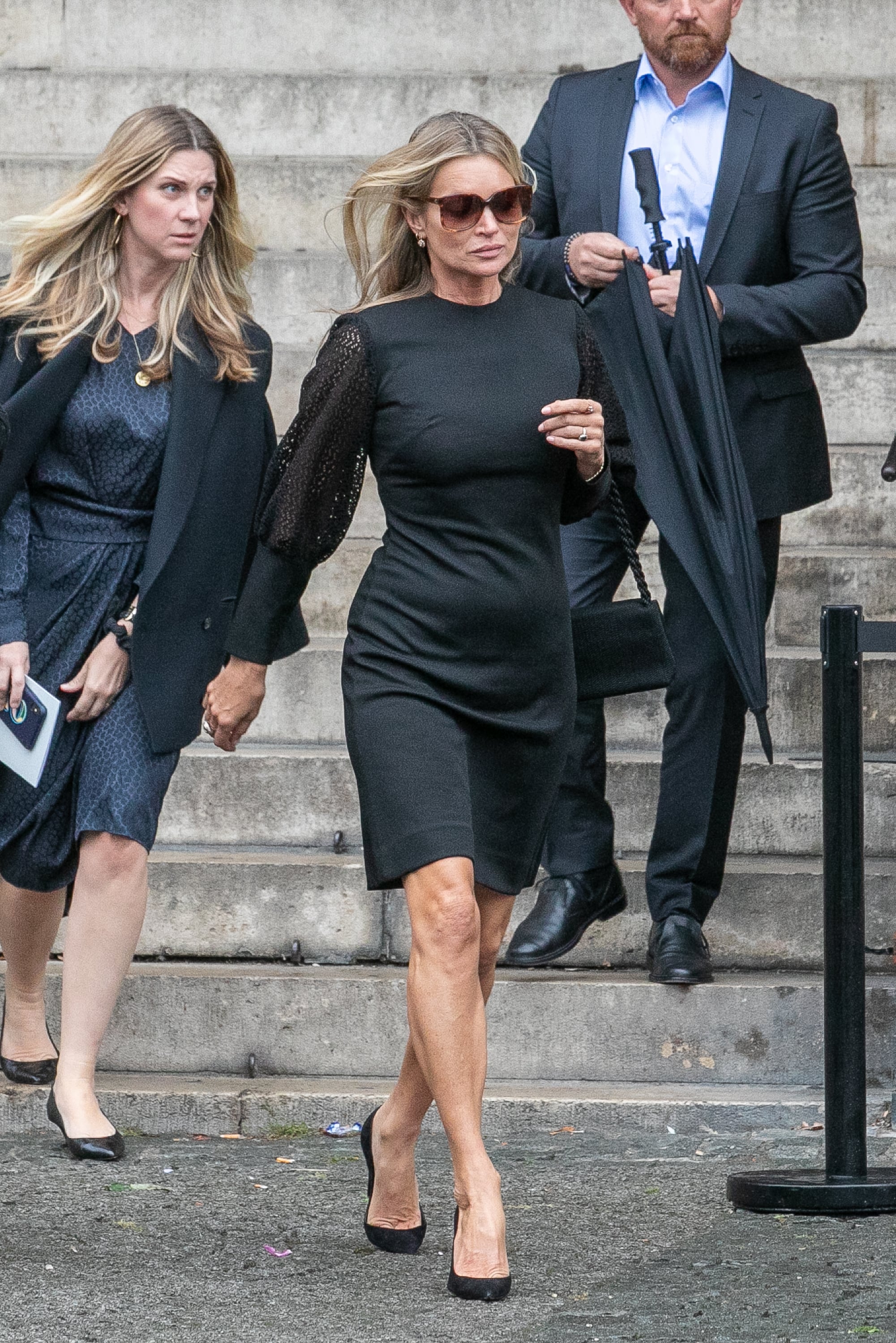 Moss looking every bit a supermodel while leaving Peter Lindbergh's funeral in a black mini-dress.