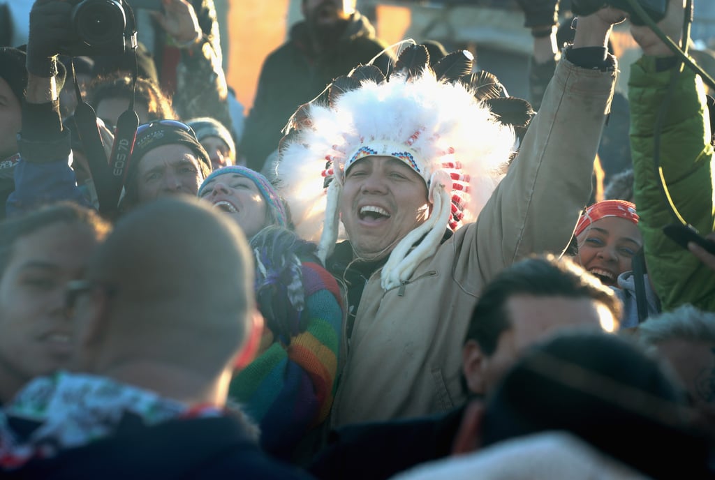 Several activists smile and celebrate their victory.