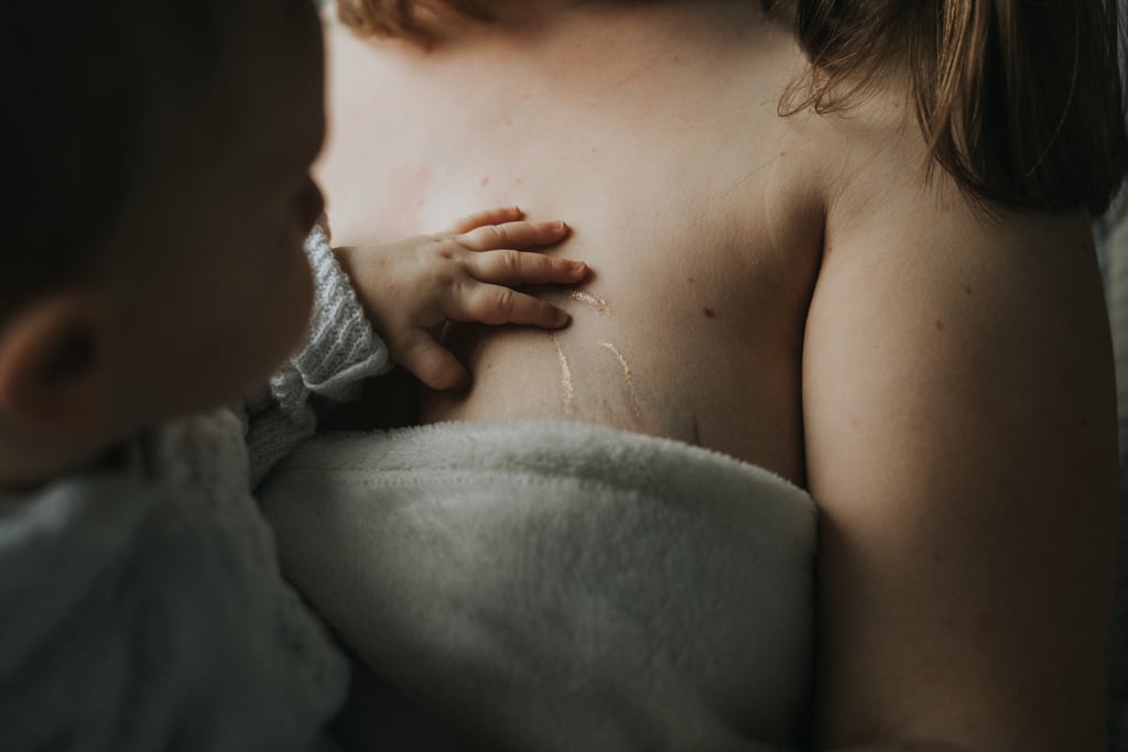 "Georgie post-breastfeeding came across the little tiger stripes we had highlighted for the Gold Dust Project on her mom's chest, and something about her tiny hands touching those stripes really reinforced the beauty of this project."