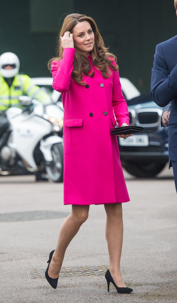 Kate let her fuchsia coat speak for itself by selecting simple, classic accessories: a small suede clutch and her go-to black pumps.