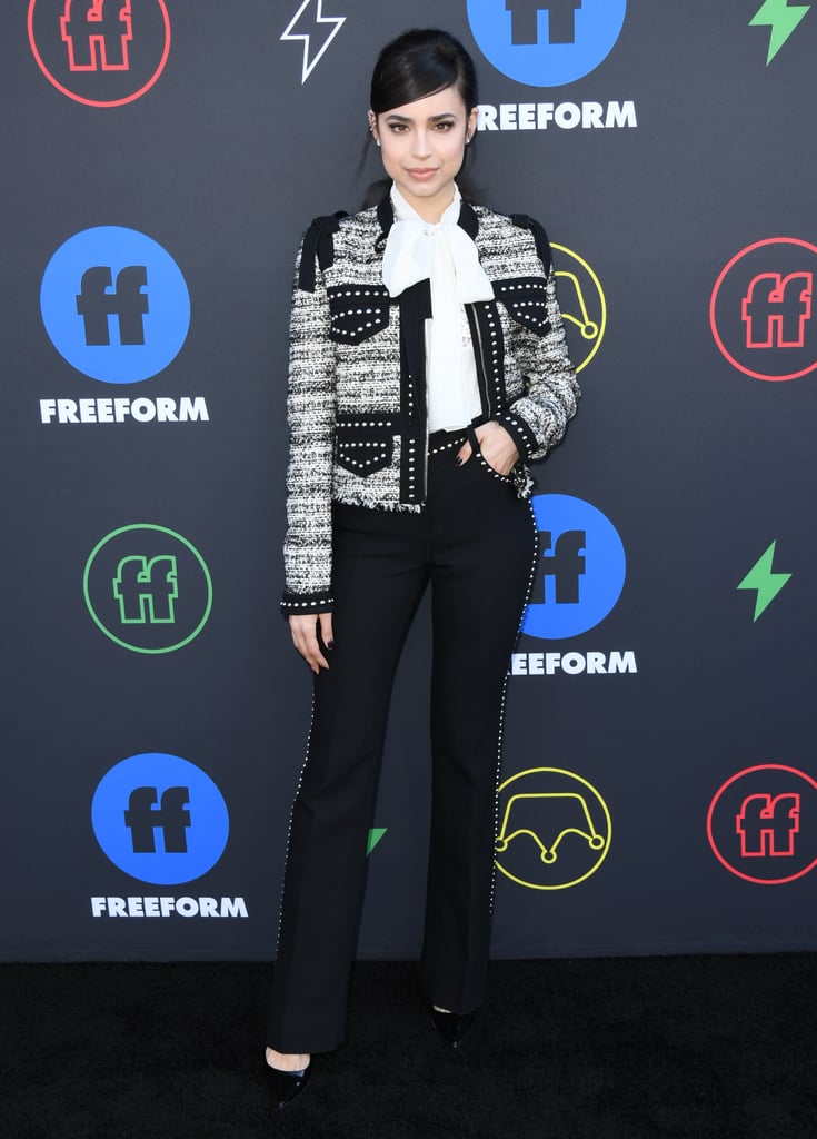 Wearing a blouse, jacket, and black pants by Giambattista Valli at the 2019 Freeform Summit.