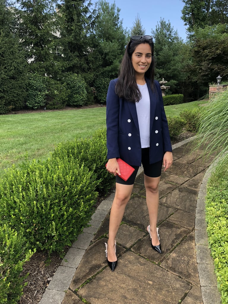 The outfit: I wore an Everlane tee underneath my Sandro double-breasted blazer. I styled it with my Good American biker shorts, Dior kitten heels, a Chanel wallet, and Quay sunglasses.