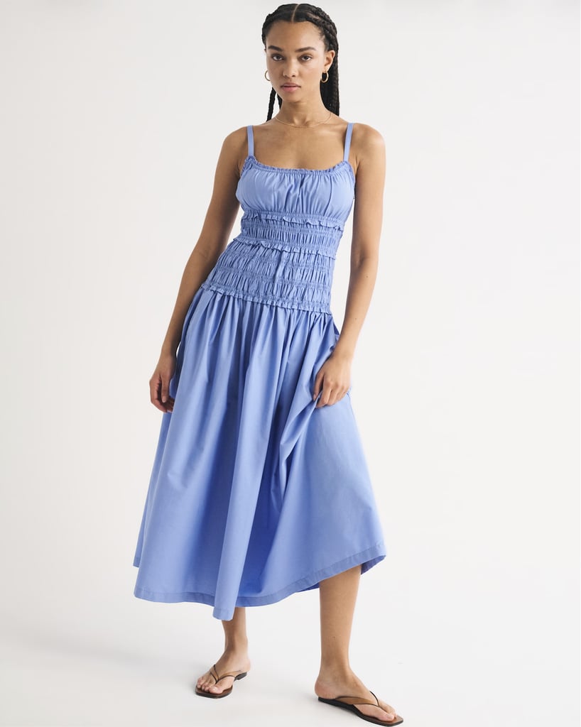 Abercrombie Bra-Free Smocked Drop-Waist Maxi Dress ($130)
Abercrombie has proven to be a go-to spot for sundresses this year, and I am personally running out of excuses not to grab some of these styles. When adding this stunning blue drop-waist style to your cart, make sure to use stackable code AFSUMMER for an additional 15 percent off almost everything.