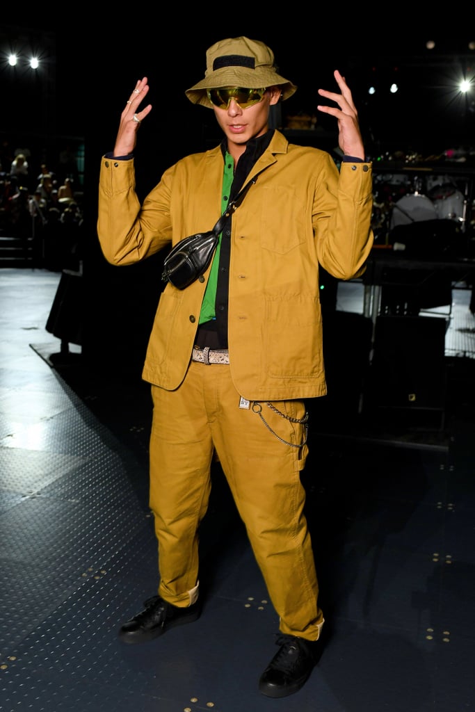 It's all about the accessories with his chic fanny pack and bucket hat.