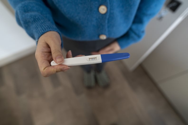 High angle view of positive pregnancy test of young mother.
