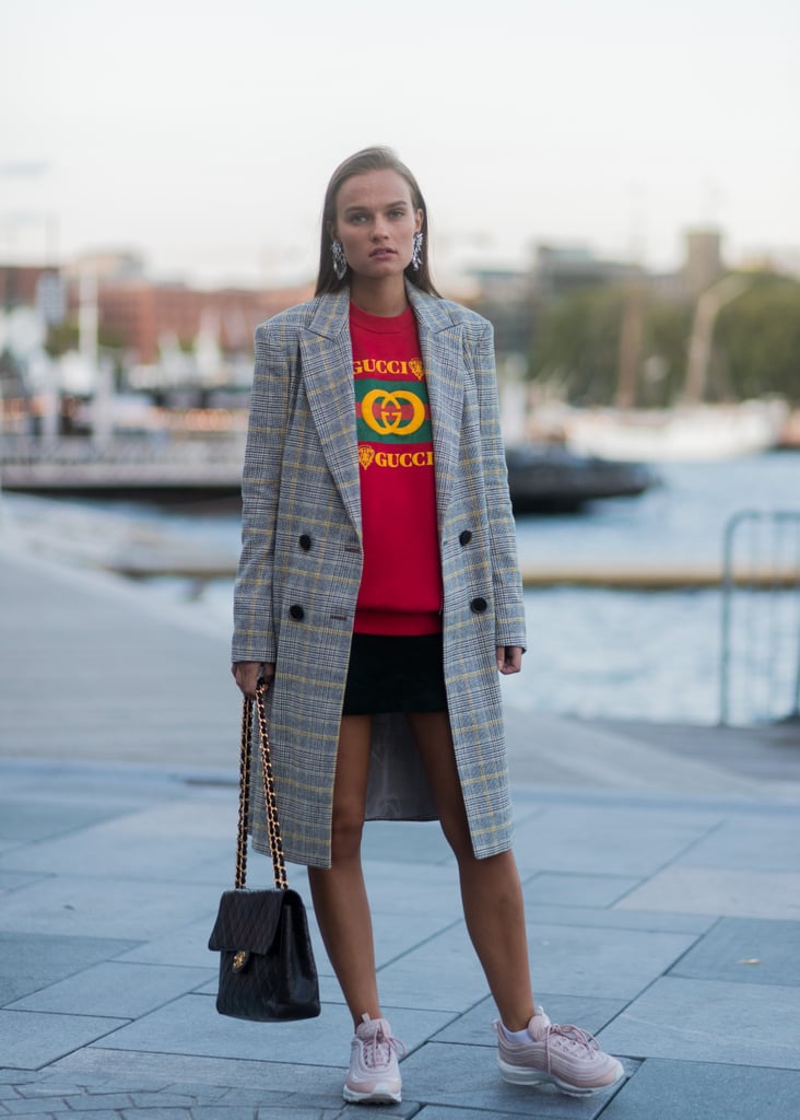 Put on your favorite black miniskirt with a sweatshirt and trainer sneakers, then throw on your long plaid double-breasted coat.