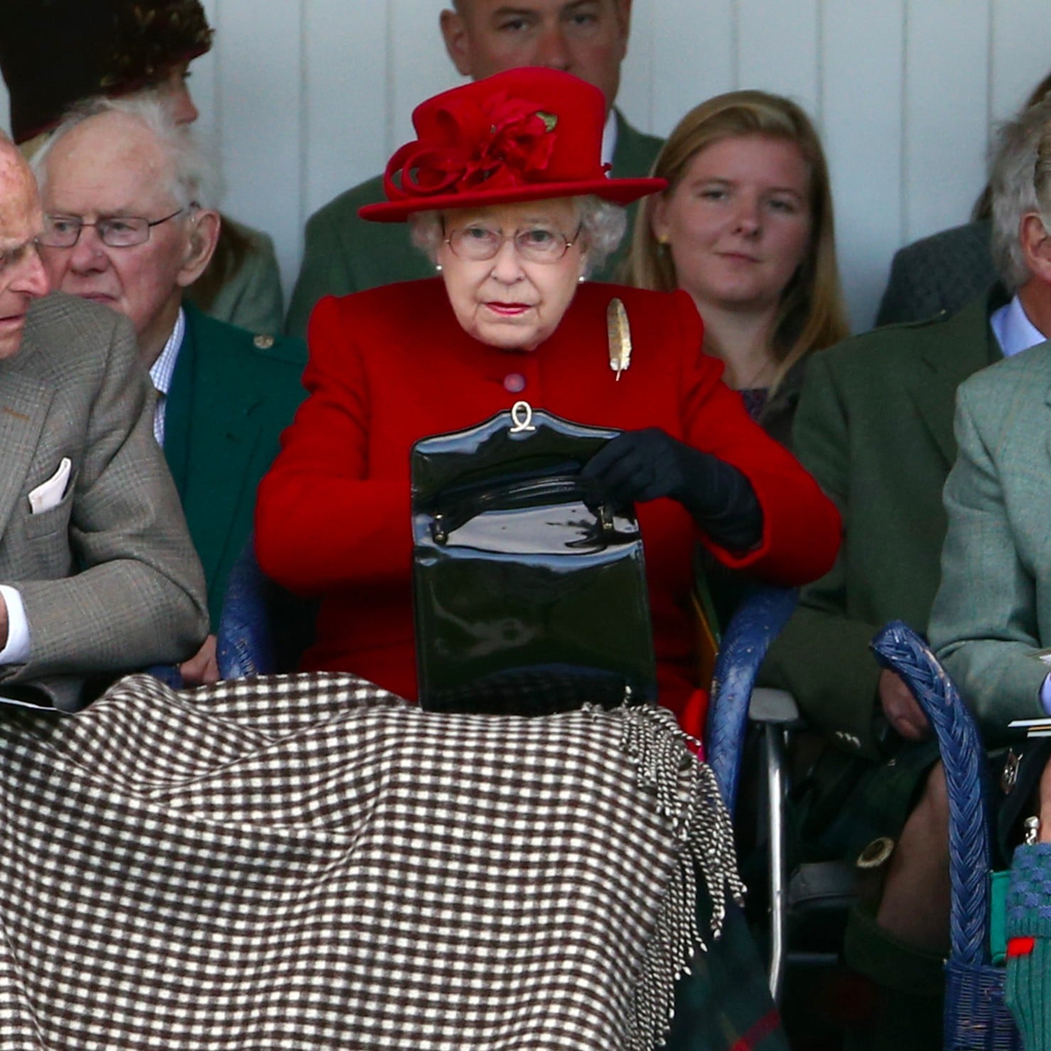 Why Does the Queen Always Carry a Purse? It Serves Multiple Purposes