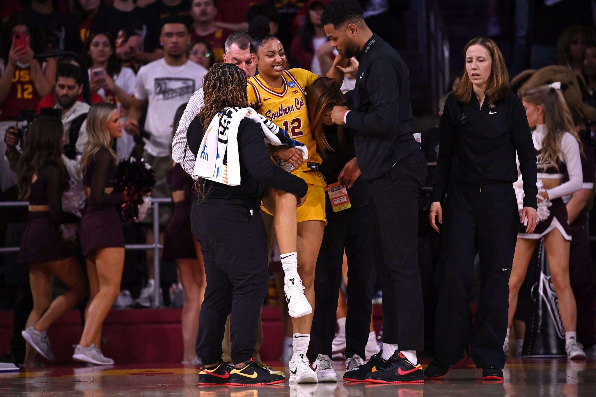 JuJu Watkins is helped up off the floor after being injured against the Mississippi State Bulldogs.