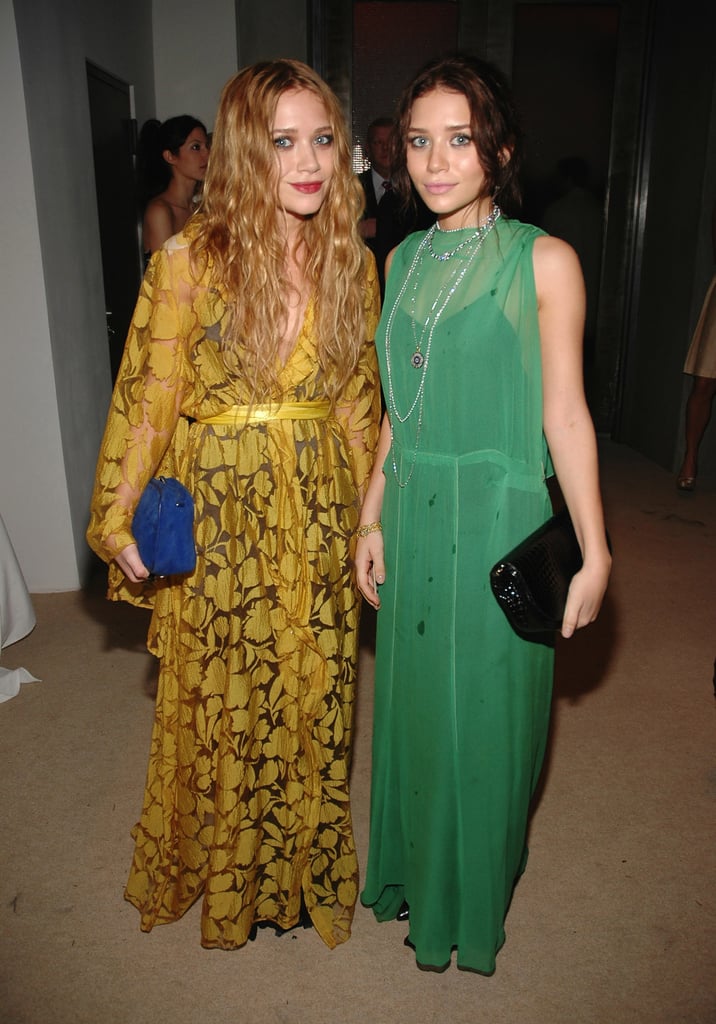 Twinning combo: For the 2006 CFDA/Vogue Fashion Fund Awards, the girls donned Autumn-friendly hues and textured box clutches.

Mary-Kate was Fall-ready in a leafy mustard-yellow wrap gown and suede cobalt clutch.
Ashley played up her dark locks in a sheer green dress, black patent leather clutch, and a few layered necklaces.