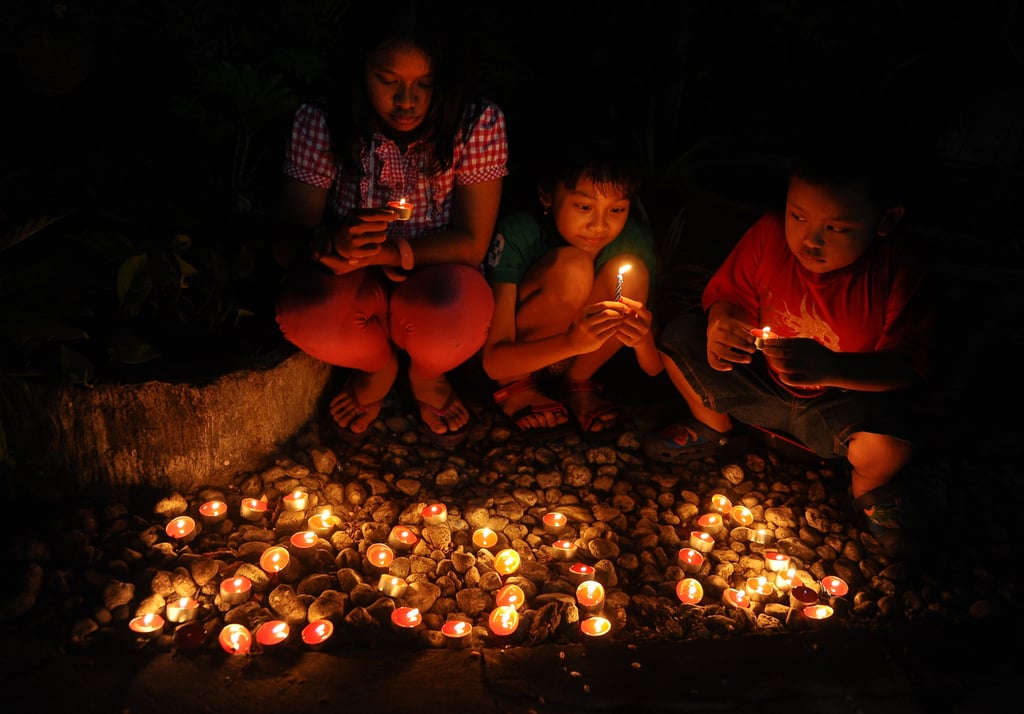 Kids lit candles and prayed to celebrate the start of 2014 in Surabaya, Indonesia.