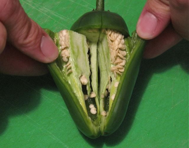 Step 3: Open the flaps to reveal all the pepper's seeds and veins. Step 3: Open the flaps to reveal all the pepper's seeds and veins.