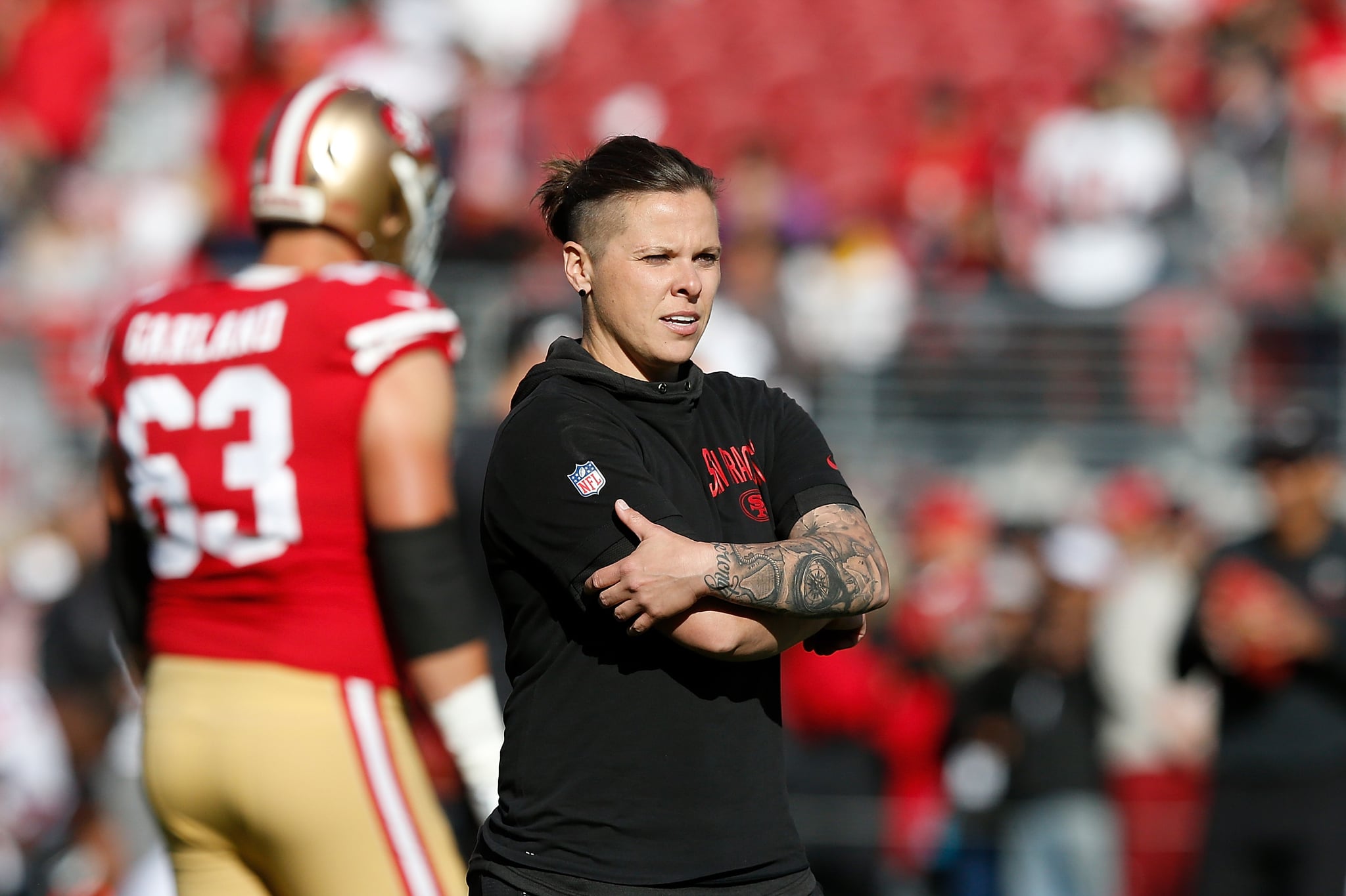 SANTA CLARA, CALIFORNIA - DECEMBER 15: San Francisco 49ers offencive assistant coach Katie Sowers looks on during the warm up before the game against the Atlanta Falcons at Levi's Stadium on December 15, 2019 in Santa Clara, California. (Photo by Lachlan Cunningham/Getty Images)