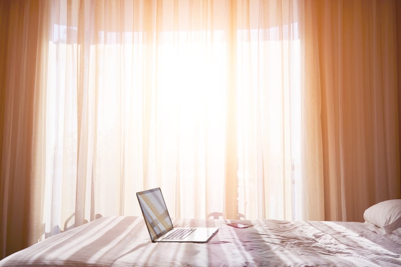 a laptop sitting on a bed
