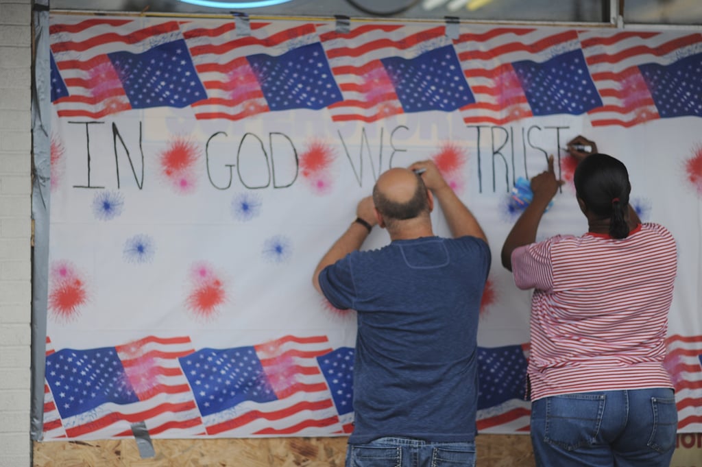 People in St. Louis signed a wall in honor of Michael Brown during a peaceful protest. People in St. Louis signed a wall in honor of Michael Brown during a peaceful protest.