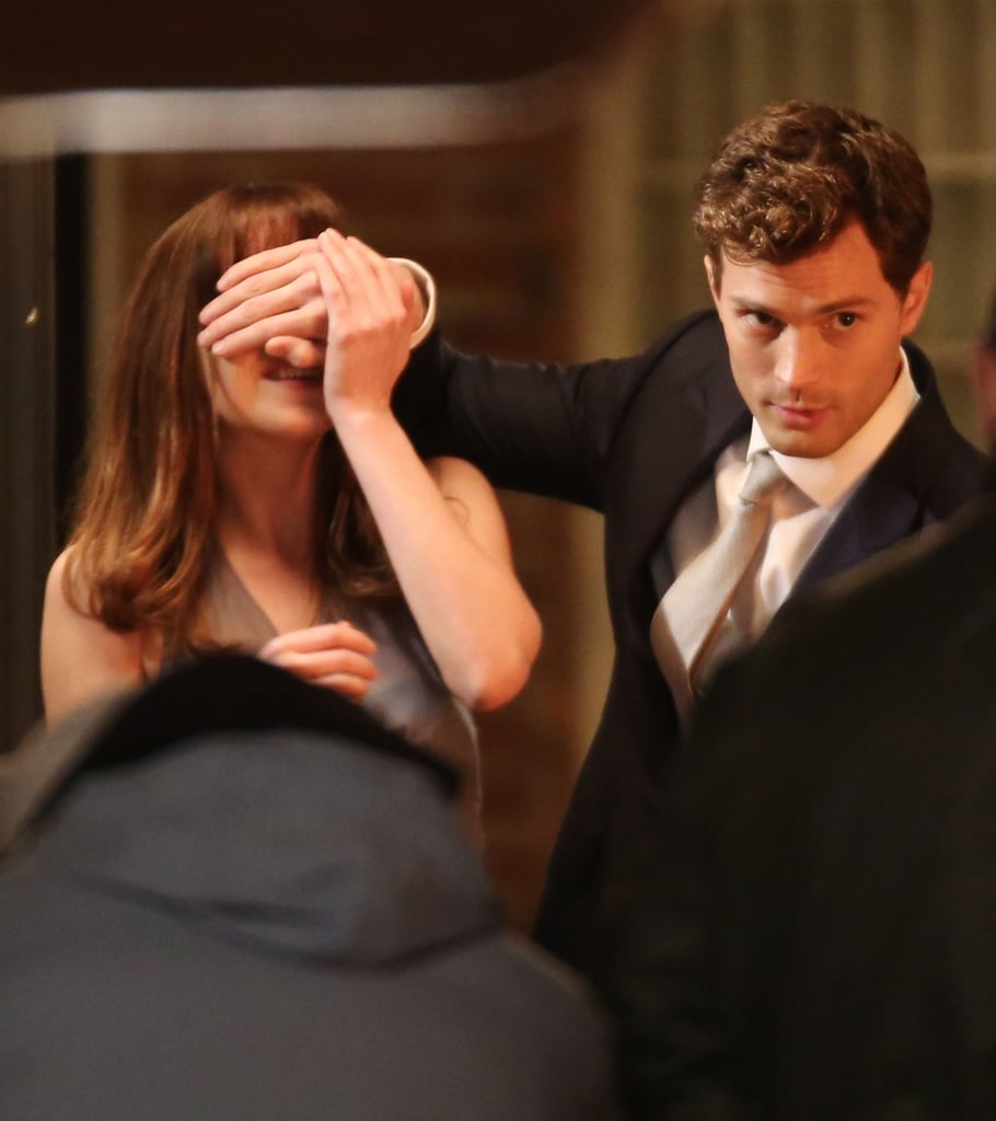 Johnson tried to pry Dornan's hand off her eyes.