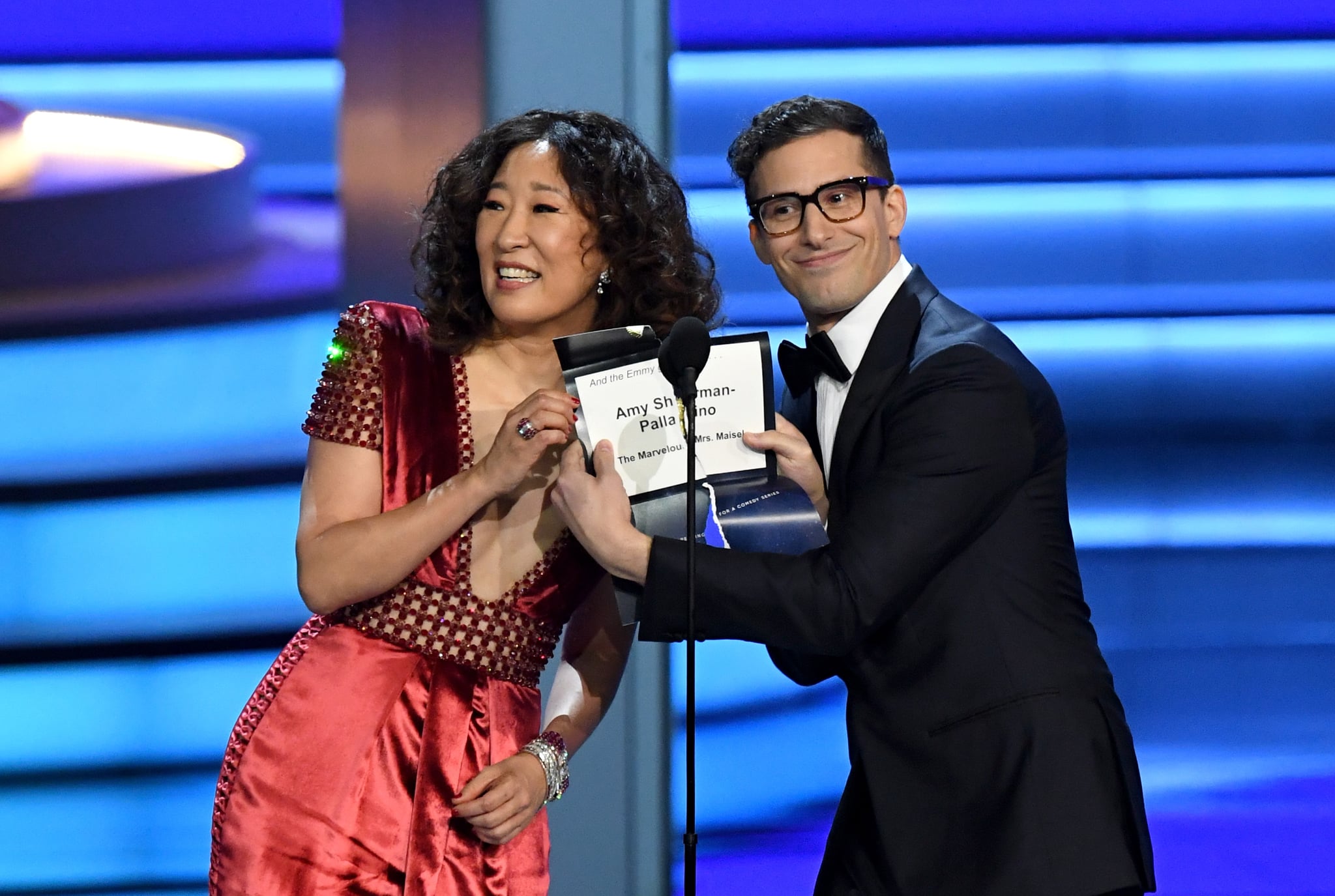 LOS ANGELES, CA - SEPTEMBER 17:  Sandra Oh (L) and Andy Samberg present the Outstanding Directing for a Comedy Series award onstage during the 70th Emmy Awards at Microsoft Theatre on September 17, 2018 in Los Angeles, California.  (Photo by Kevin Winter/Getty Images)