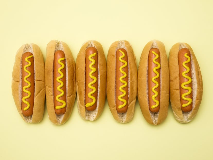 Hot dogs against a plain background.