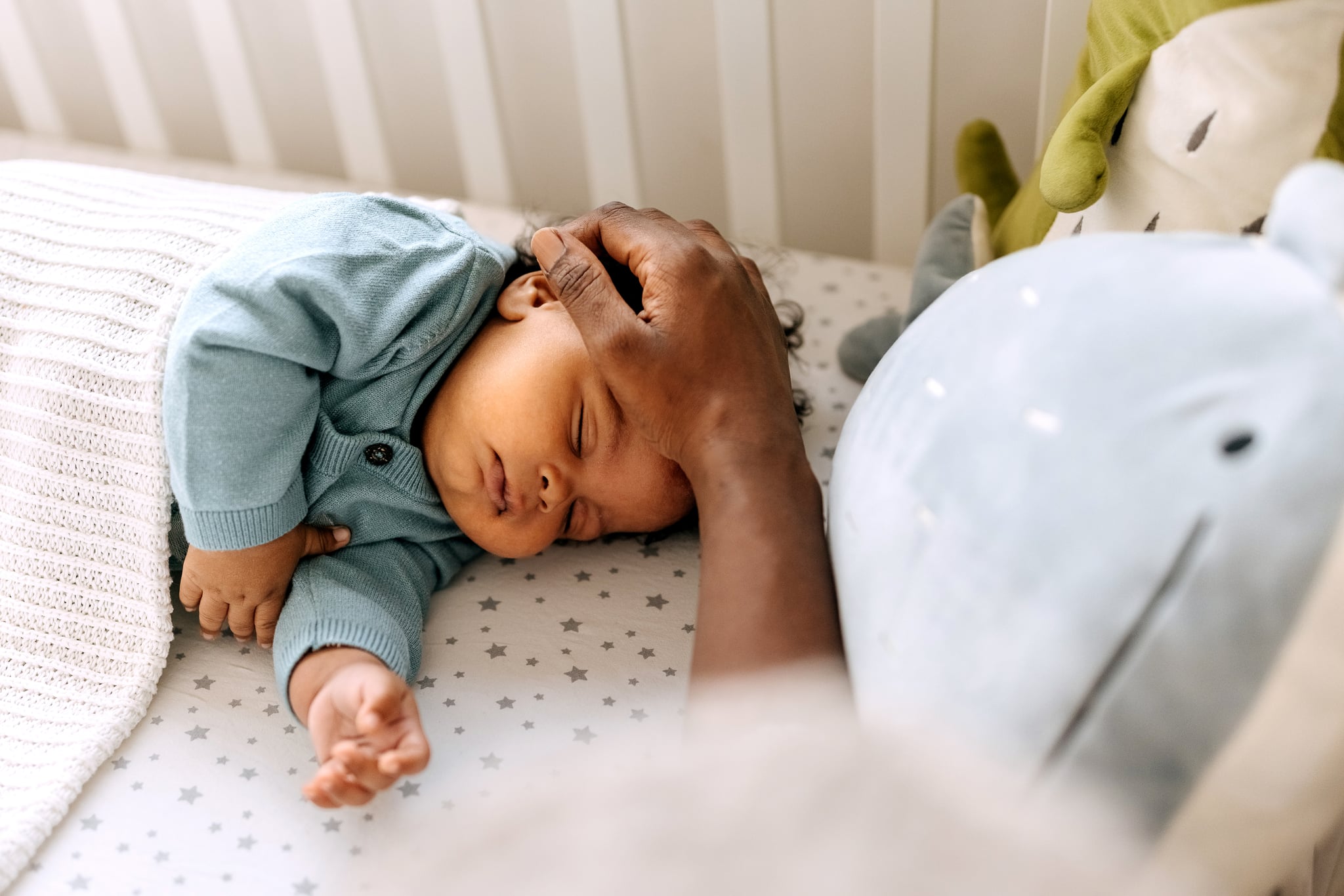 Mother putting her baby boy asleep