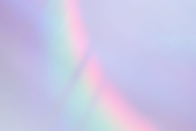 Abstract lavender-colored wall with a shiny iridescent holographic rainbow overlay light effect. Interest in lavender marriage is spiking among Gen Z since the election.