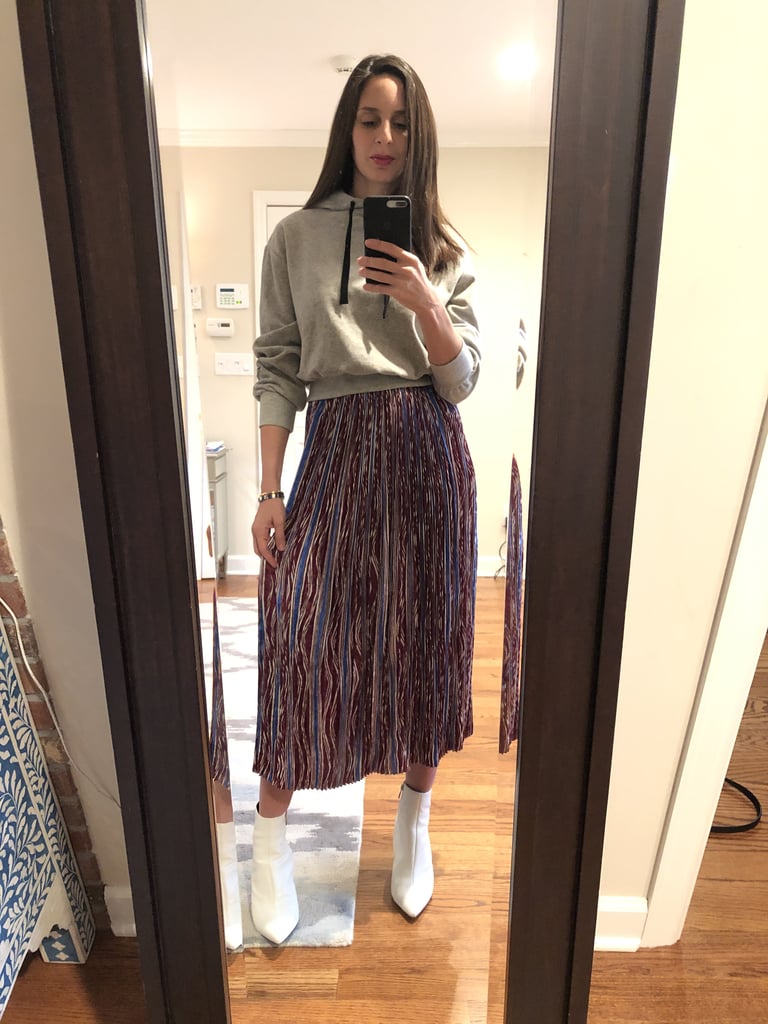 One hoodie two ways! Dana rocked the same colorway with a pleated midi skirt and her white leather ankle boots.