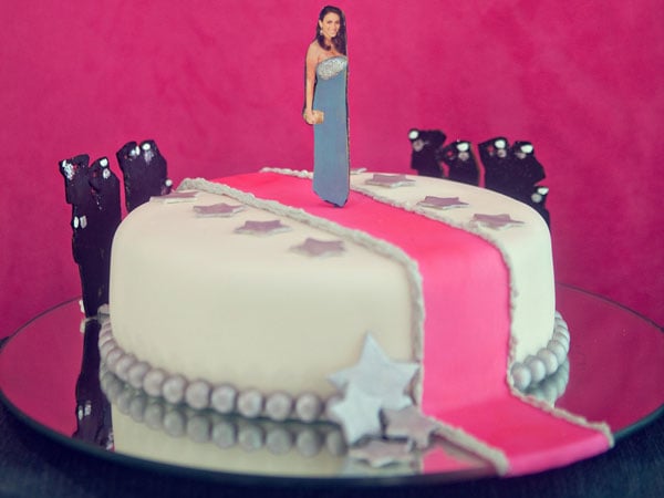 The star-adorned cake (by Gabriela Xacur of Gourmet Sweets) featured a cutout of the bride-to-be strutting her stuff on a pink carpet. Surrounded by paparazzi, naturally.