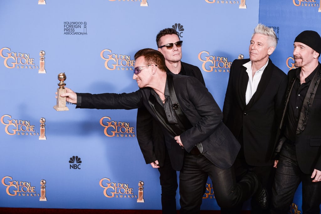 Bono held out his Golden Globe for all to see after U2 won the best original song award for "Ordinary Love" from Mandela: Long Walk to Freedom.