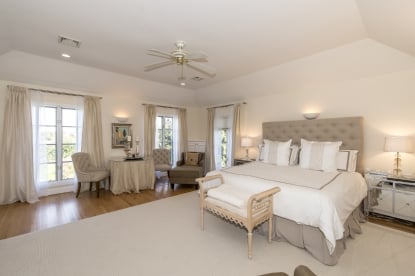 This bedroom, one of six, features a crisp, clean color palette.