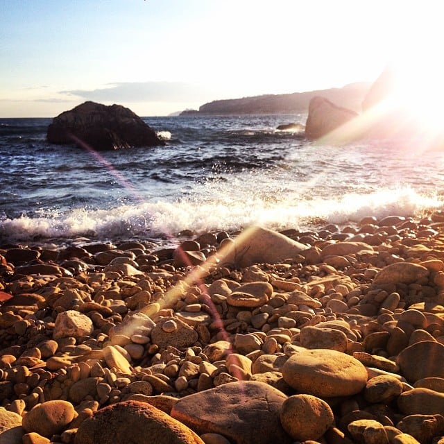 We caught this sunset snap of the waves crashing against a rocky beach. Heavenly!