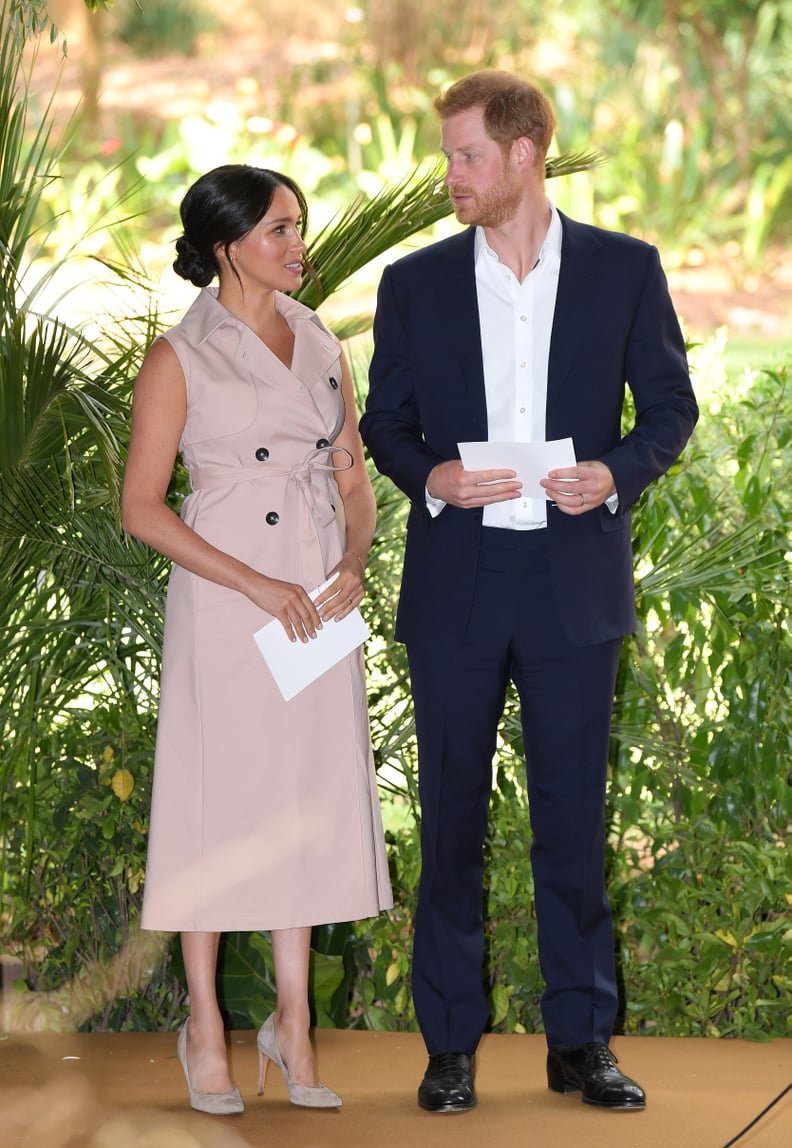 Meghan, Duchess of Sussex Wearing A Beige Sleeveless Belted Trench Dress