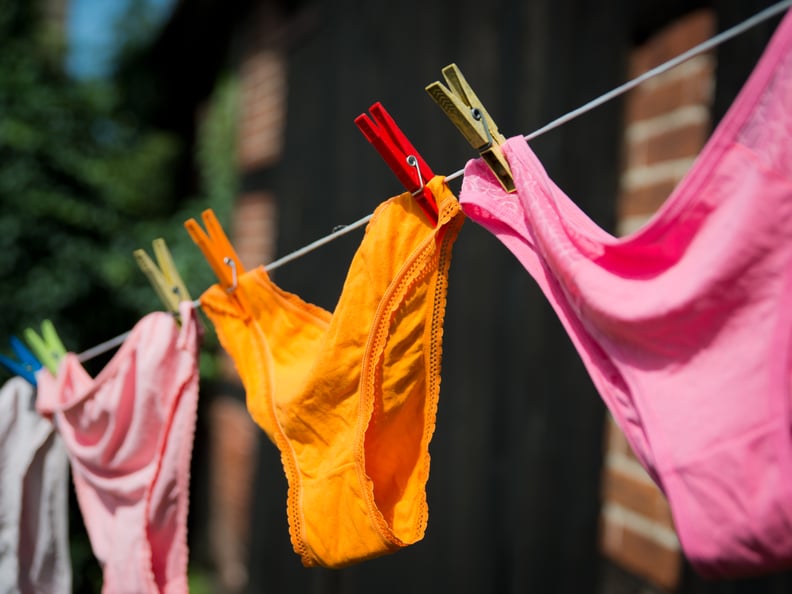Orange underwear pinned on clothing line.