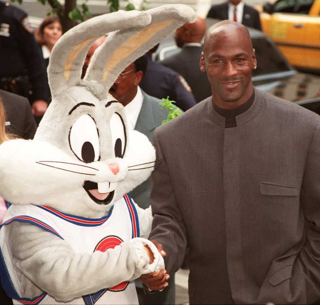 Michael wore a snazzy collarless suit to celebrate the Warner Bros. New York City store opening in 1996.