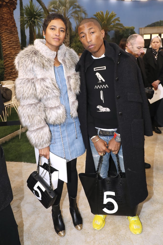 Pharrell Williams and his wife, Helen Lasichanh, went for denim and bold outerwear.