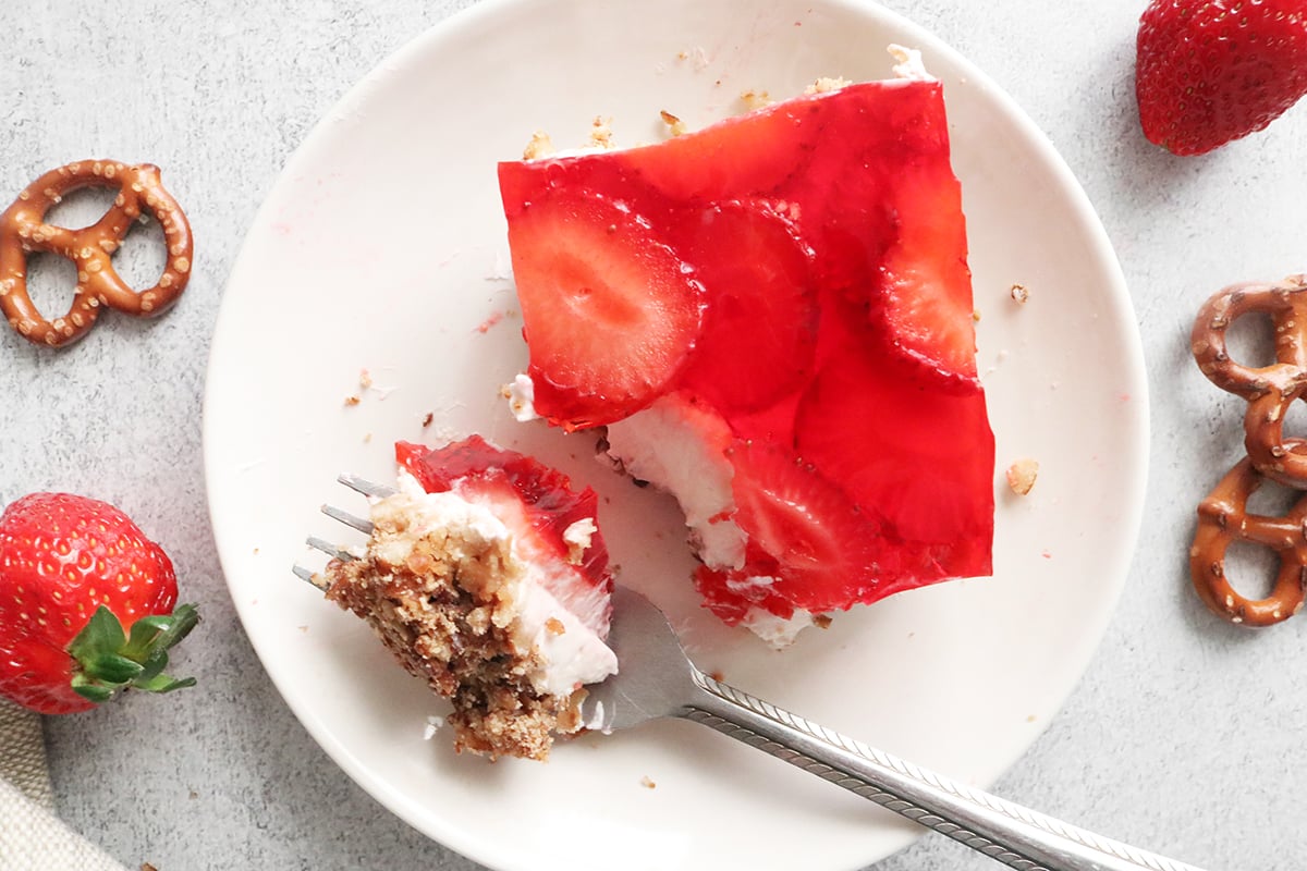 Slice of strawberry pretzel salad on a white plate