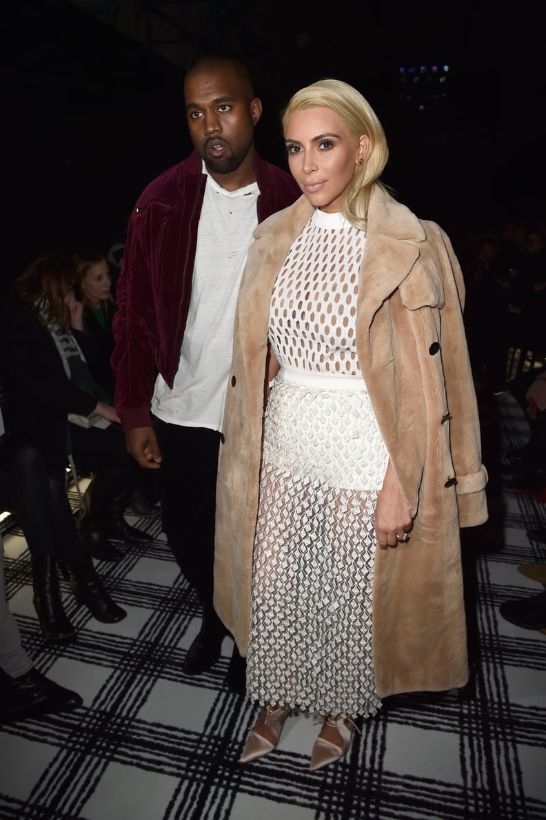 Kim turned out a high-fashion Balenciaga look for PFW, while Kanye turned to his trusty zip-up.