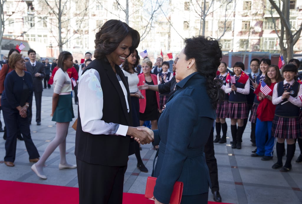 Students holding American flags were on hand to welcome the first lady.