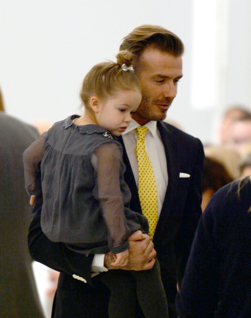 David Beckham held his daughter, Harper, at his wife's show on Sunday.