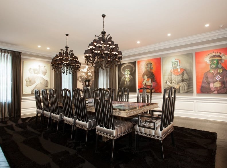 Large paintings and dark decor give the dining room a gothic-chic feel.