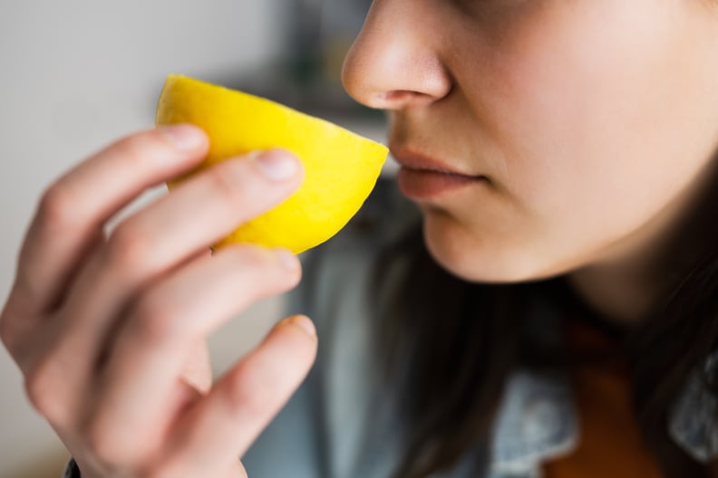 Woman Nose Sniffing Lemon Smell. Coronavirus Symptom