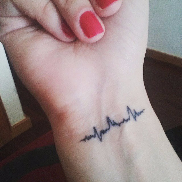 Heartbeat tattoo located on the inner arm.