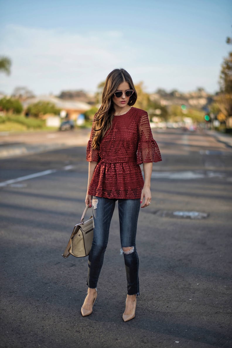 A lace peplum with destroyed jeans and beige pumps.